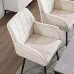 cream-velvet-dining-chairs-with-armrests-set-at-table